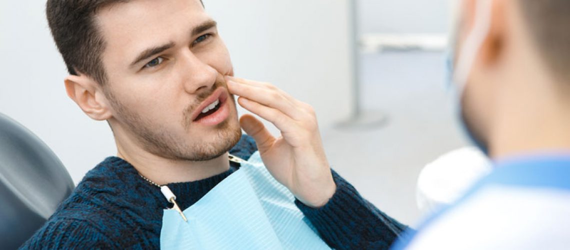Dental Patient Suffering From Mouth Pain On A Dental Chair, In Williamsville, NY